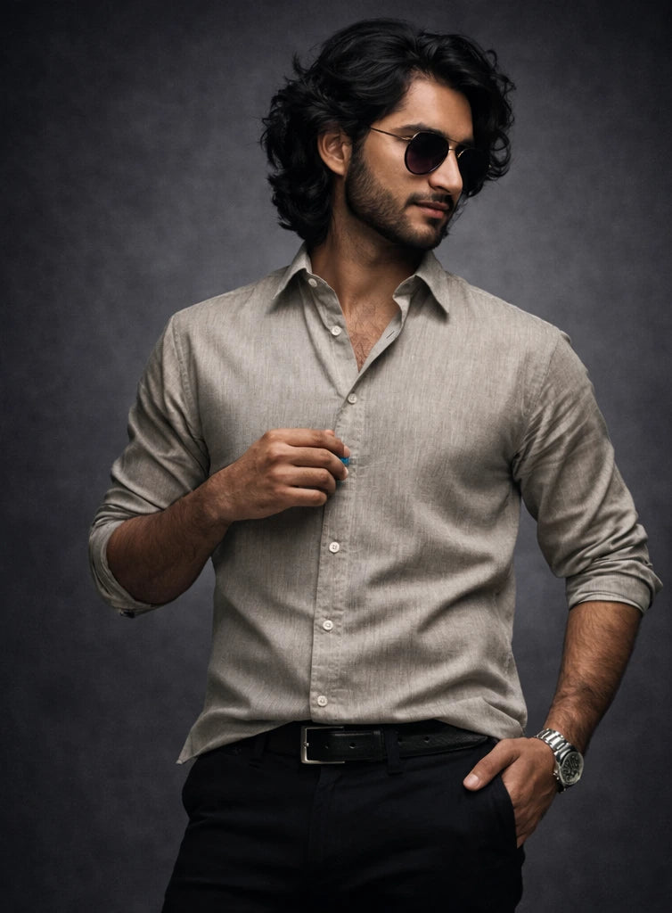 Man wearing a light olive  shirt and sunglasses against a white background