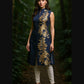 Woman wearing a navy blue dress with gold embroidery in a forest setting