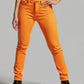 Person wearing bright orange pants on a plain background