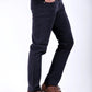 Person wearing black pants and brown shoes on a white background