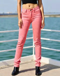 Person wearing pink jeans standing by a waterfront