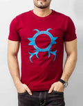 Man wearing a red t-shirt with a blue logo on a plain background