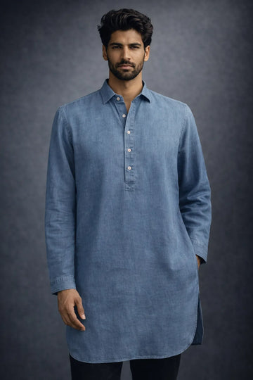 Man wearing a blue long-sleeve shirt against a dark background