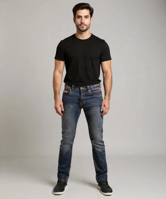 Man wearing a black t-shirt and blue jeans on a gray background