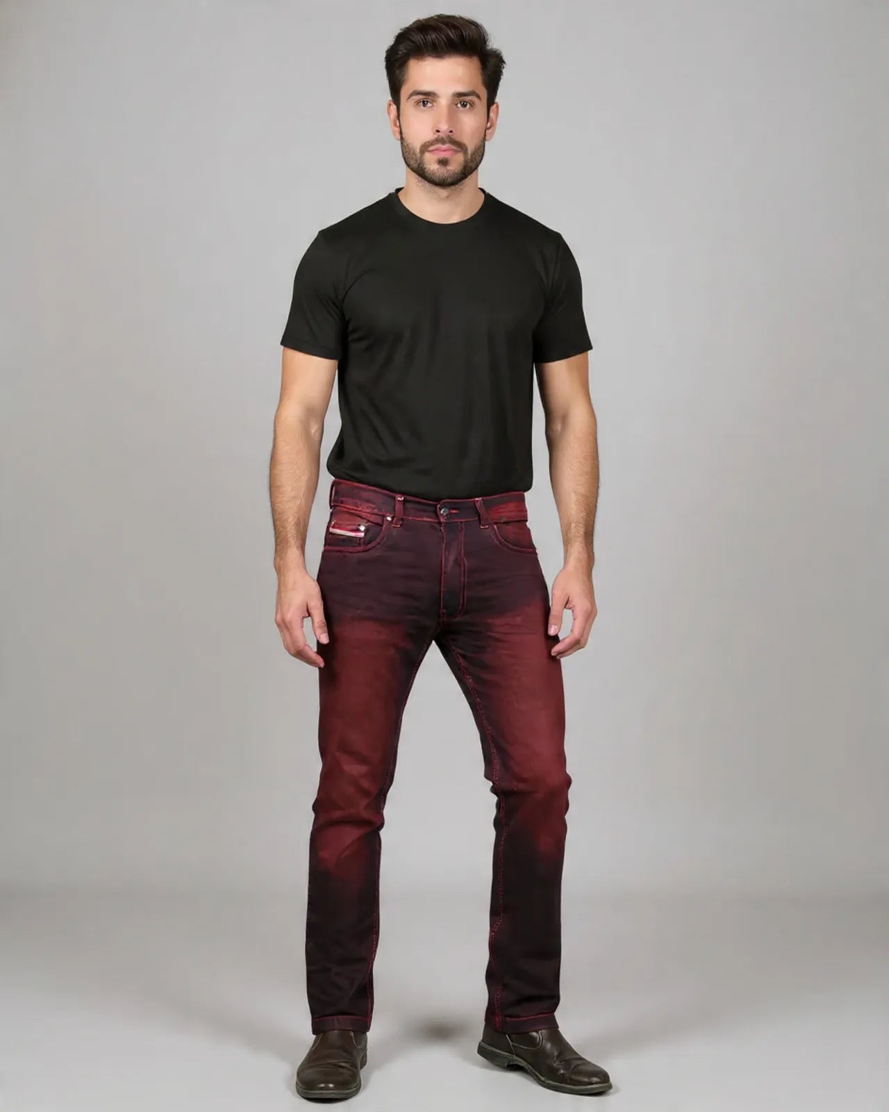 Man wearing a black t-shirt and red jeans on a gray background