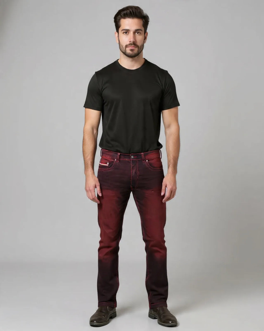 Man wearing a black t-shirt and red jeans on a gray background