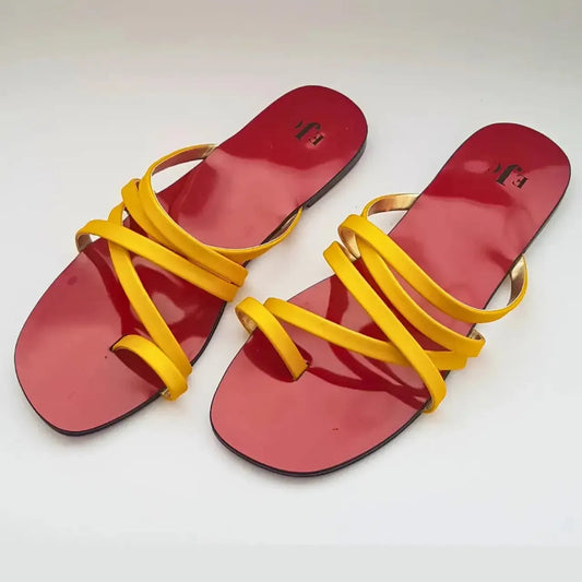 Red sandals with yellow straps on a white background