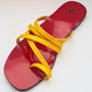 Red sandal with yellow straps on a white background