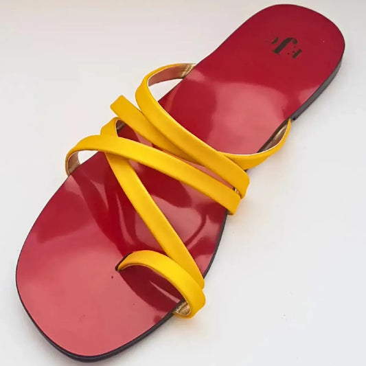 Red sandal with yellow straps on a white background