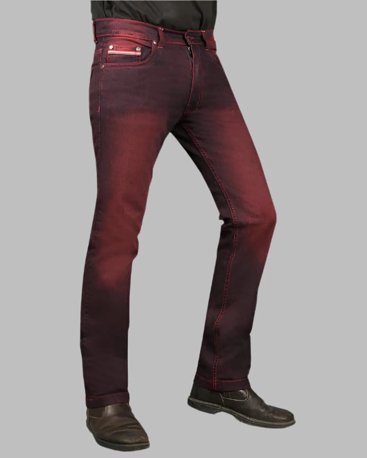 Maroon jeans worn by a person on a gray background