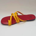 Red sandal with yellow straps on a white background