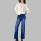 Woman wearing a white blouse and blue jeans on a gray background