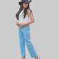 Woman wearing a white top, blue jeans, and a dark hat on a white background