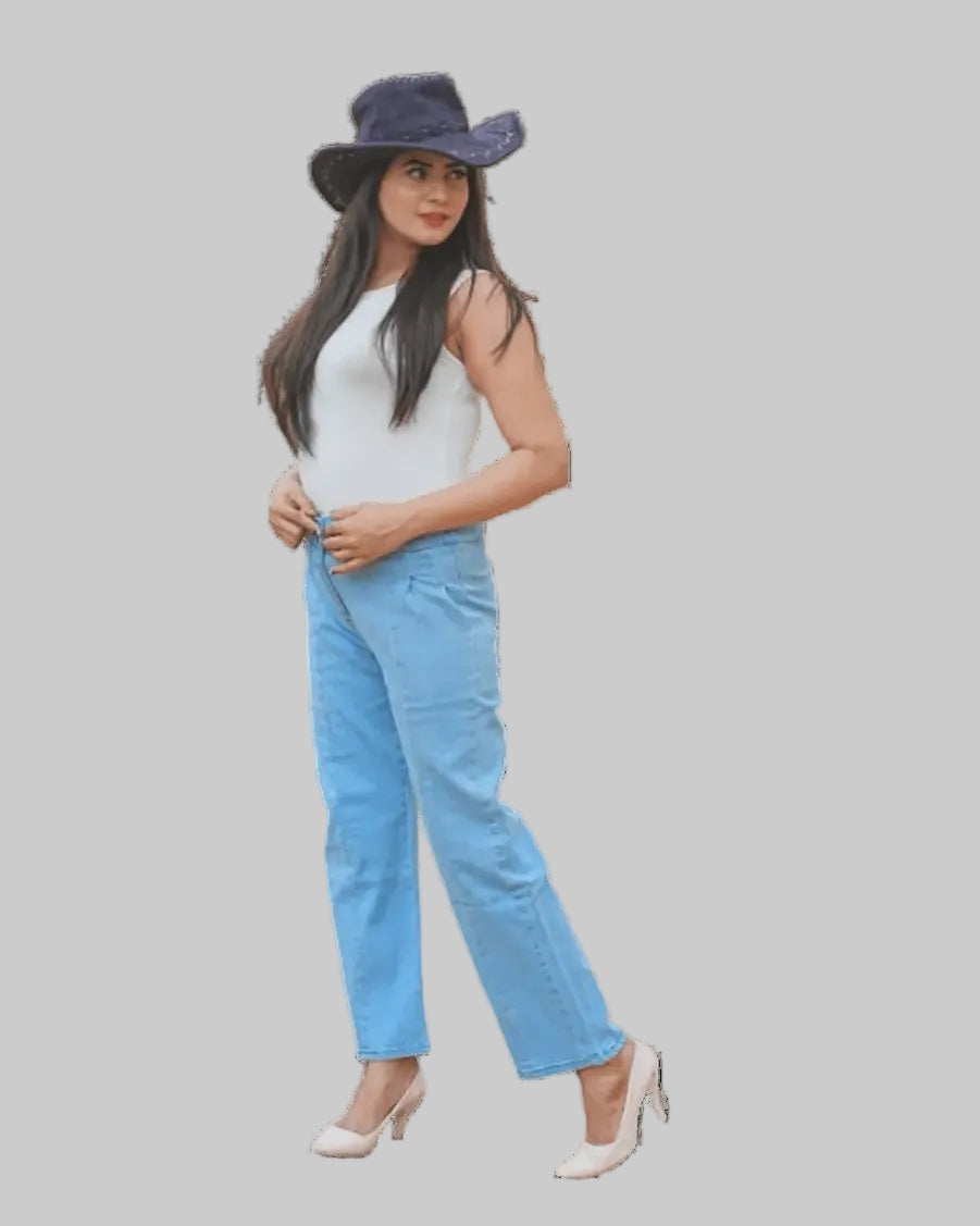 Woman wearing a white top, blue jeans, and a dark hat on a white background