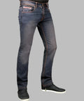 Dark blue jeans worn by a person on a gray background
