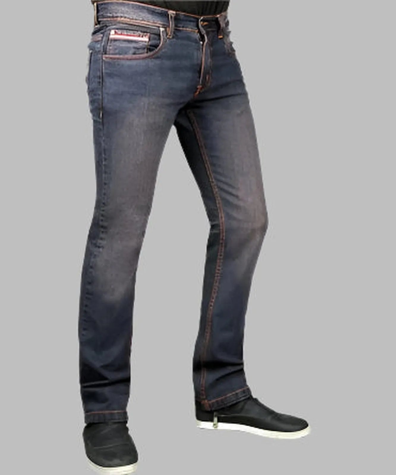 Dark blue jeans worn by a person on a gray background