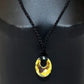 A Swarovski crystal circle pendant necklace on a black mannequin.