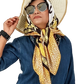 A woman wearing a denim shirt and jeans, accessorized with a gold and black digital printed silk scarf.