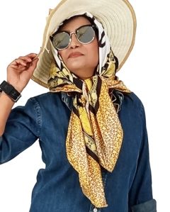 A woman wearing a denim shirt and jeans, accessorized with a gold and black digital printed silk scarf.