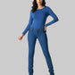 Woman wearing a blue long-sleeve top and jeans on a white background