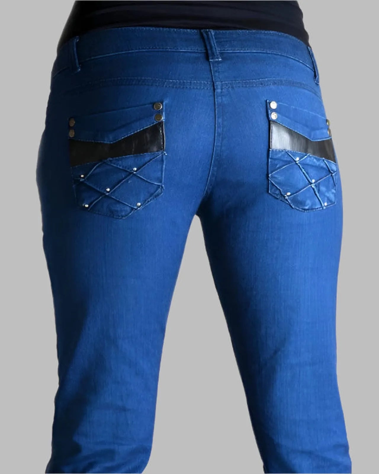 Blue jeans with decorative stitching on a gray background