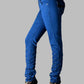 Blue jeans with embellishments on a gray background