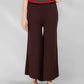 Brown wide-leg pants worn by a person on a gray background