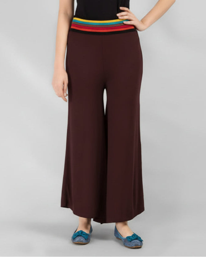 Brown wide-leg pants worn by a person on a gray background