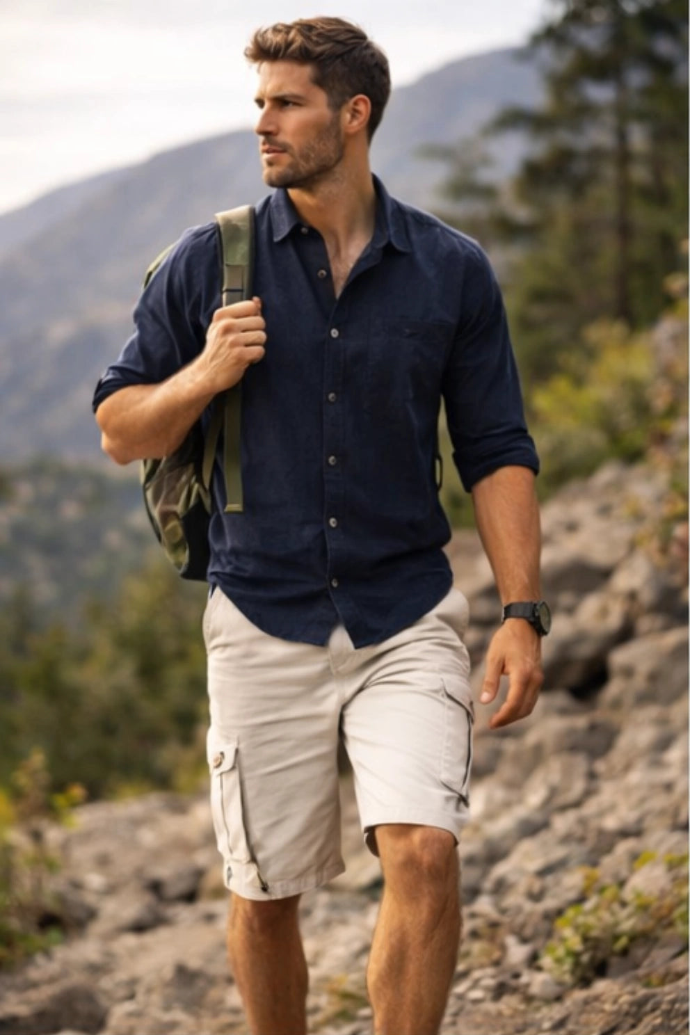 Man hiking outdoors with mountains and trees in the background