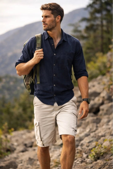 Man hiking outdoors with mountains and trees in the background