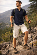 Man hiking on a mountain trail with trekking poles and a backpack.