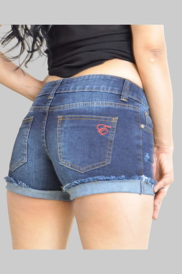 Person wearing blue denim shorts with a visible brand logo on a plain background
