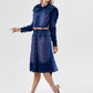 Woman wearing a blue denim dress on a white background