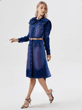 Woman wearing a blue denim dress on a white background