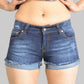 Person wearing blue denim shorts on a plain background