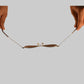 Two hands holding a delicate necklace on a white background