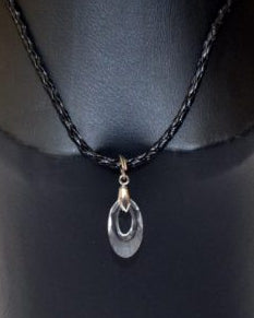 A Swarovski Helix Pendant displayed on a mannequin, featuring a clear, drop-shaped crystal pendant suspended from a black braided leather string.