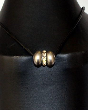 A black leather string necklace with a Swarovski pearl and crystal rondelle displayed on a mannequin.