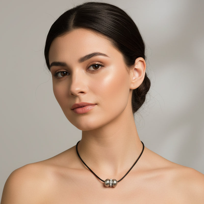Necklace with a large spherical pendant on a mannequin bust.