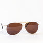 Aviator sunglasses with brown lenses on a white background