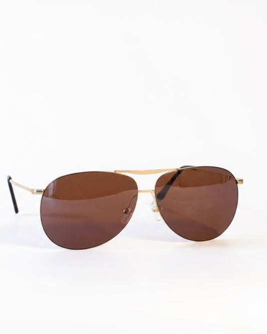 Aviator sunglasses with brown lenses on a white background