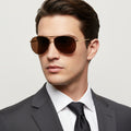 Aviator sunglasses with brown lenses on a white background