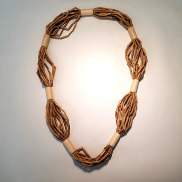 Brown woven necklace on a light gray background