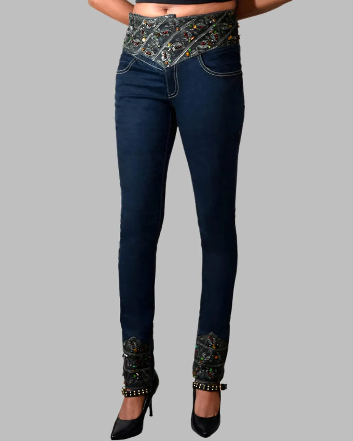 Dark blue jeans with decorative elements on a gray background