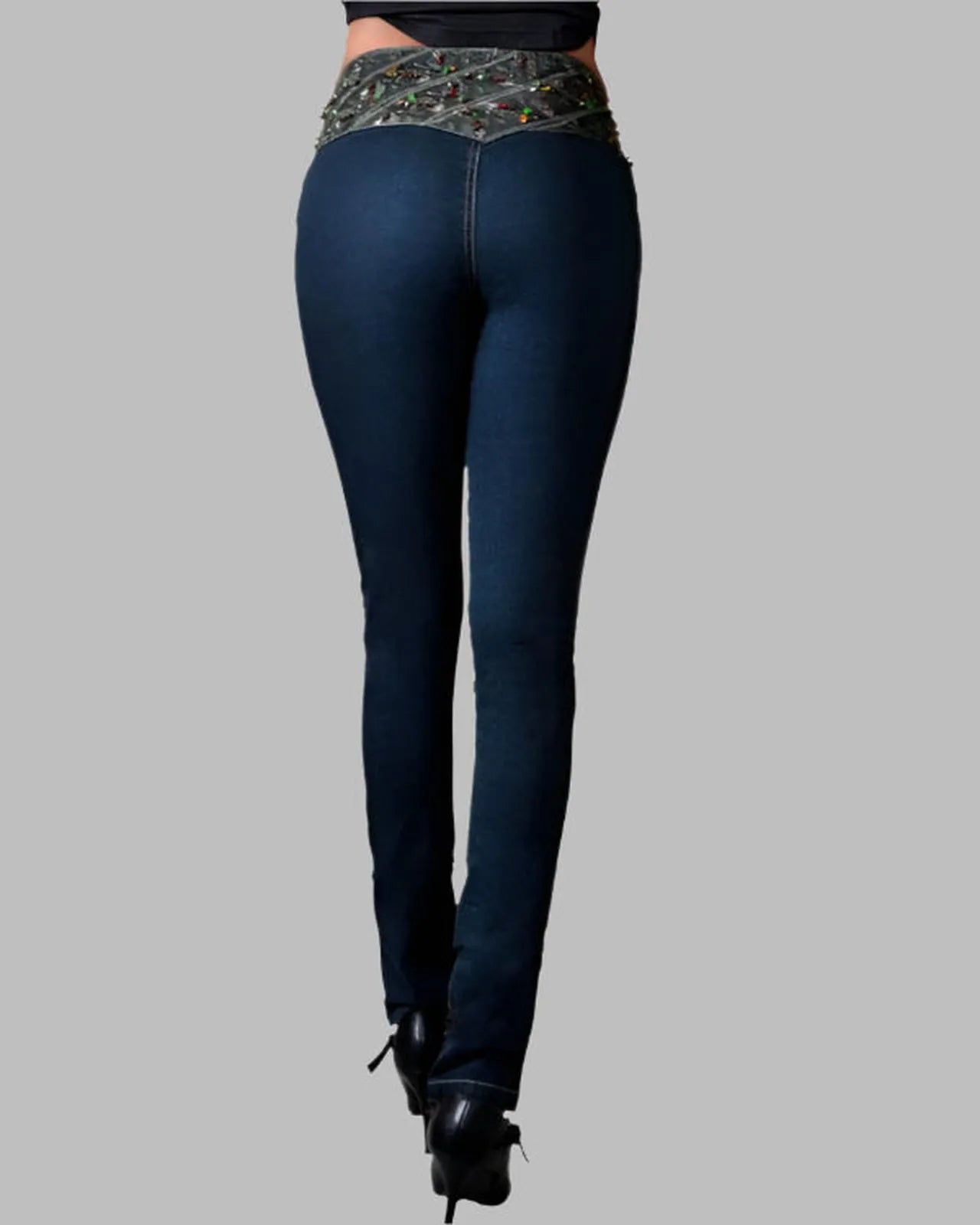 Dark blue jeans worn by a person on a gray background