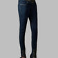 Dark blue jeans with patterned waistband and hem on a gray background