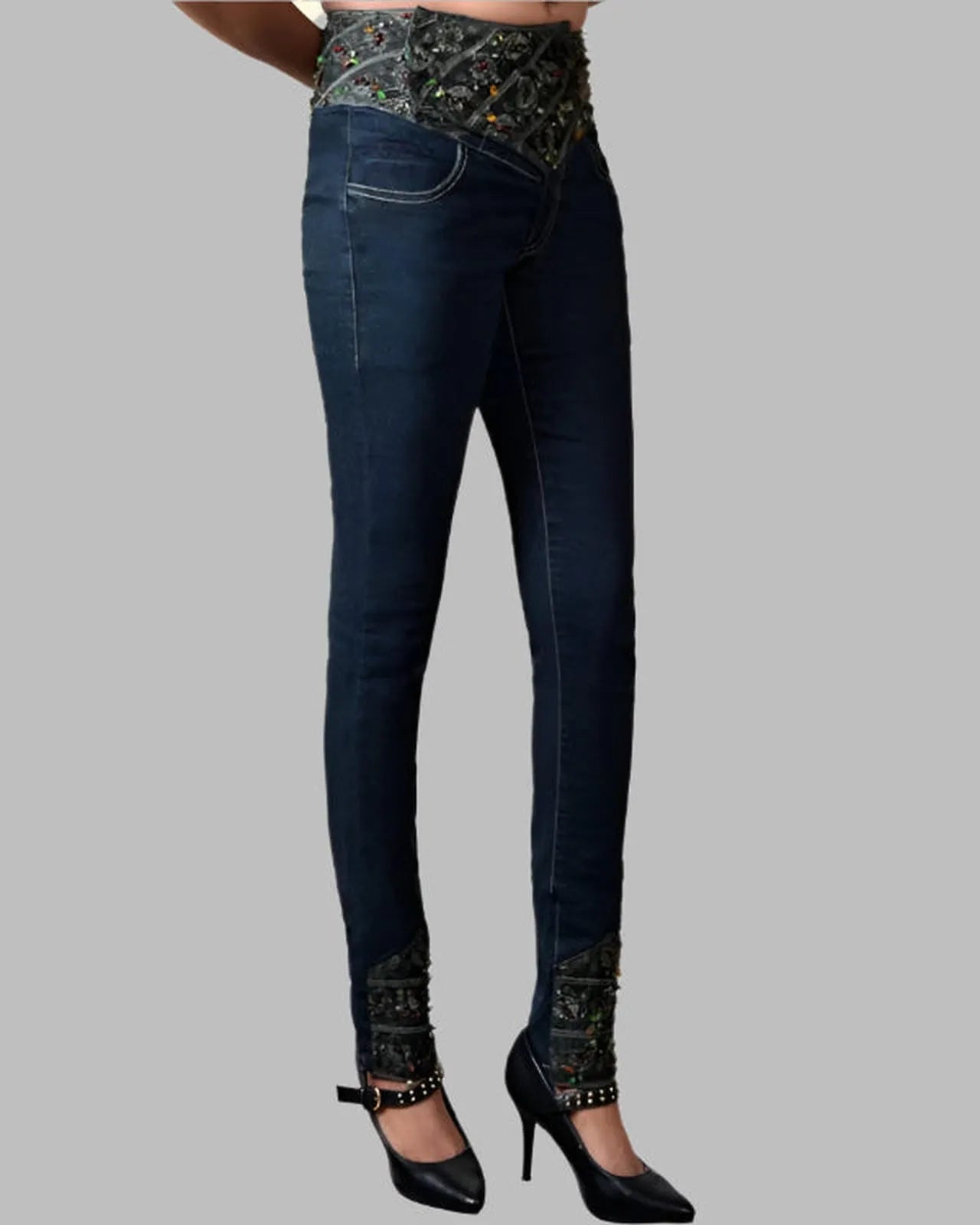 Dark blue jeans with patterned waistband and hem on a gray background