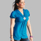 Woman wearing a blue top and jeans on a gray background