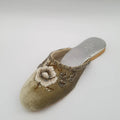 Decorative slipper with beadwork on a light gray background