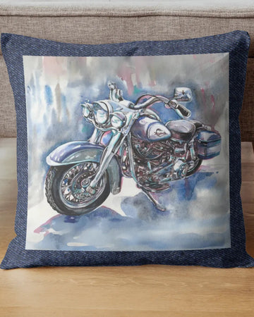 Decorative pillow with a motorcycle design on a wooden floor.